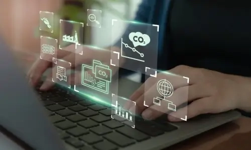 Using a laptop and digital icons representing CO2 tracking, environmental data integration and transparent carbon management