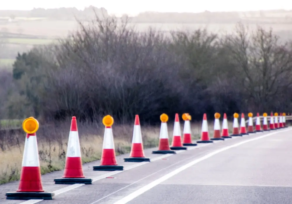 Blog Header Traffic cones lined along the side of a high speed road